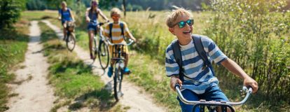 4 people cycling through a field