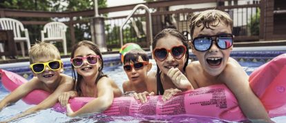 Children playing in swimming pool on campsite in France