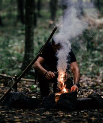 Hand man making camp fire on outdoor