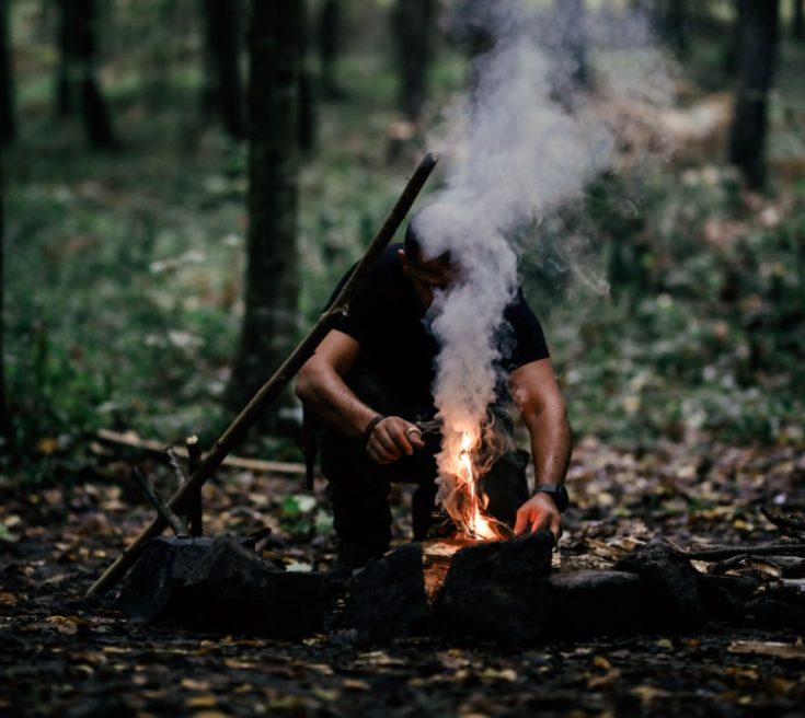 Hand man making camp fire on outdoor