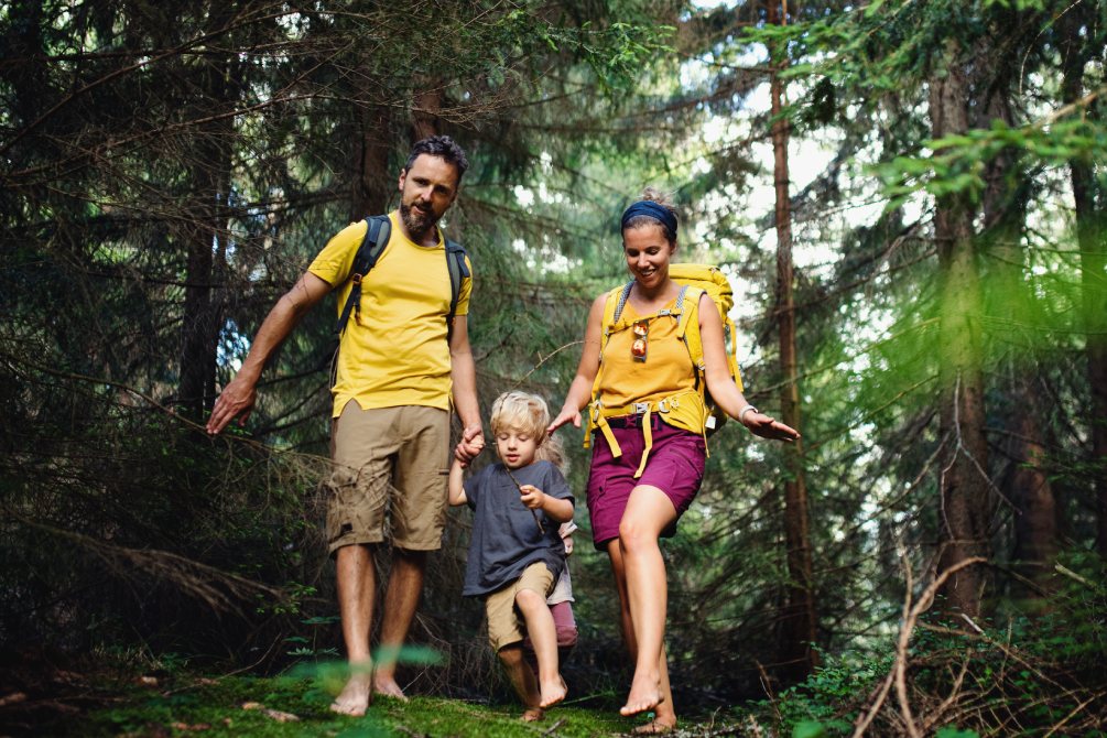 Une famille marche pieds nus dans la nature