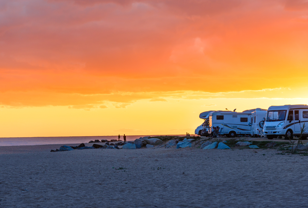 Campervans at a beach at sunset - Des campings-cars à une plage