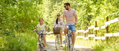 happy family riding bicycles on cycle path