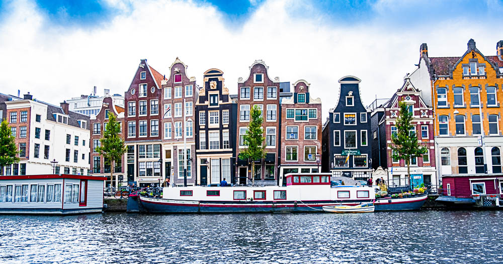 typical houses and a canal boat in Amsterdam