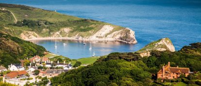 British seaside and coastal scene, the popular Lulworth cove on the Jurassic coast, Devon - campsites in England