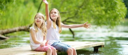 Due bambine sedute in riva al fiume - Campeggi a Agen