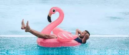 Man relaxing in a pool while it's rainingCampsited Weather Guarantee Holiday Insurance