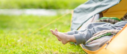 Little girl resting in a tent in a green field - Campsites in La Roche sur Yon