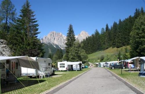 campsite in the Dolomites. Caravans with mountains in the background