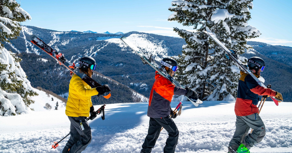 group carrying skis in beautiful snowy location