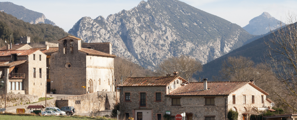 Landscape of Oix, Spain. Medieval buildings with mountain backdrop