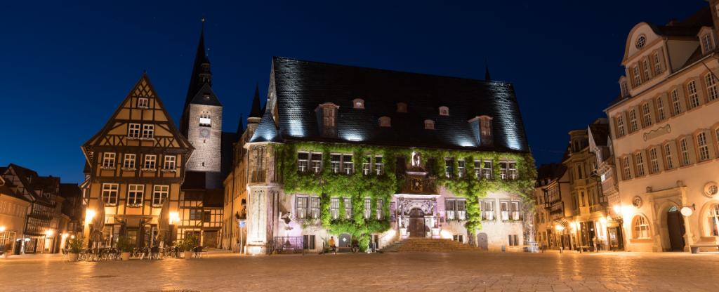 The town of Quedlinburg, buildings softly lit at night.