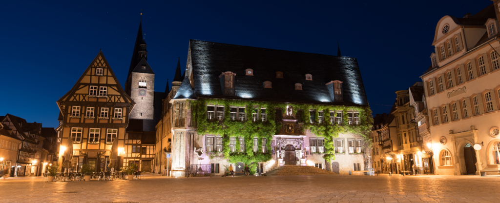 The town of Quedlinburg, buildings softly lit at night. 