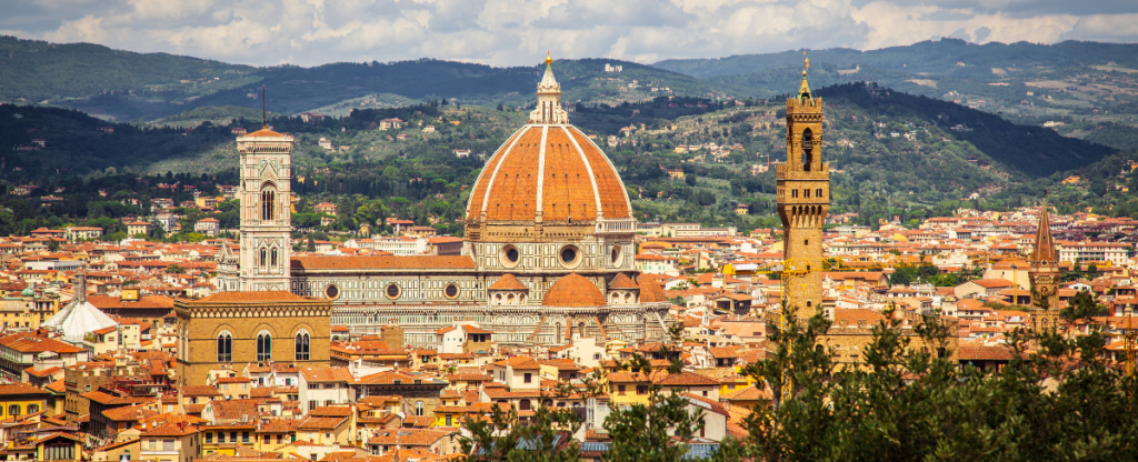 birdseye view of Florence's iconic red rooftops and marble mountains