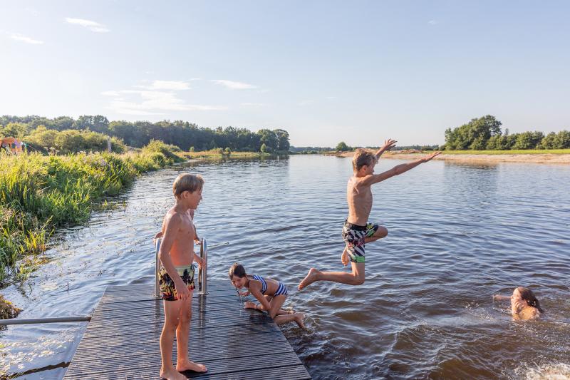 Children swimming in a lake, Overijssel