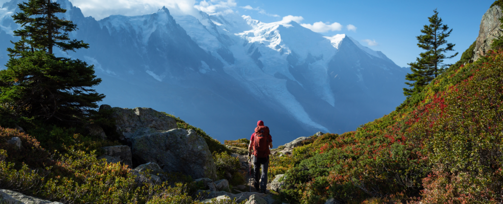 Man with backpack hiking in the Chamonix Valley in France 