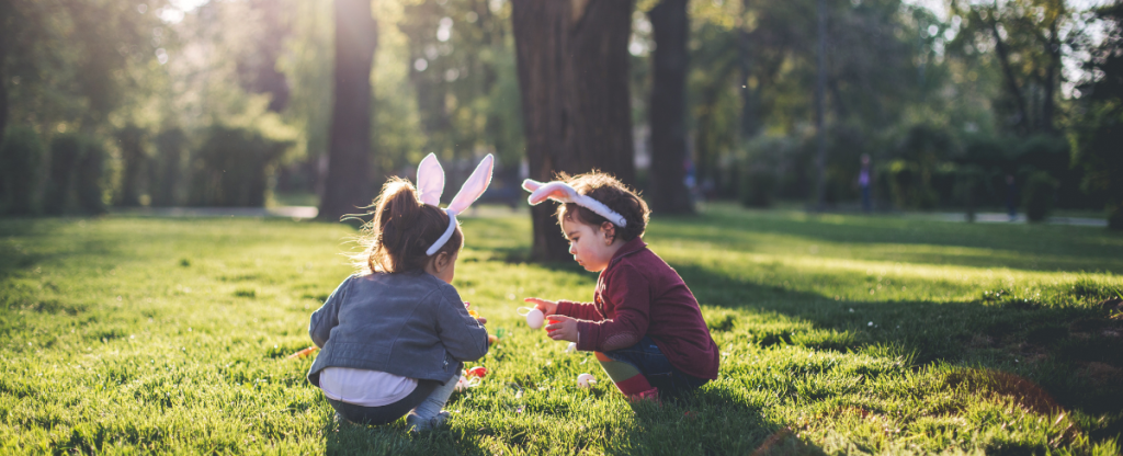 2 toddlers playing an Easter Egg Game in the woodlands